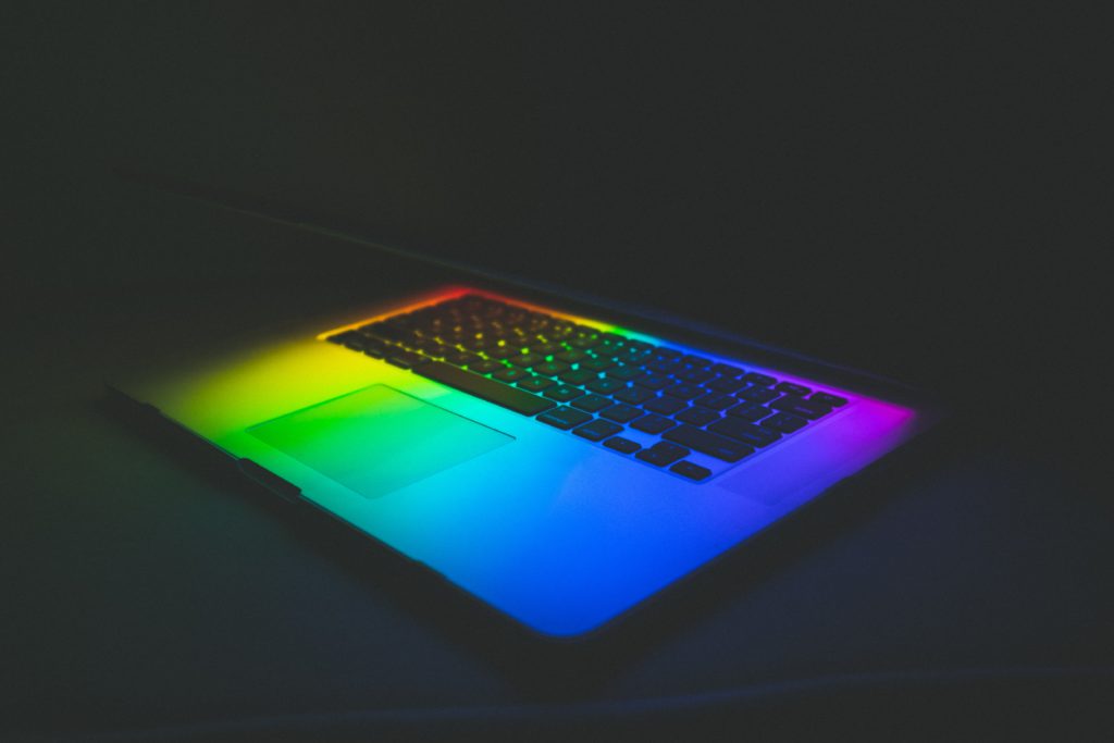 laptop half open with rainbow colors