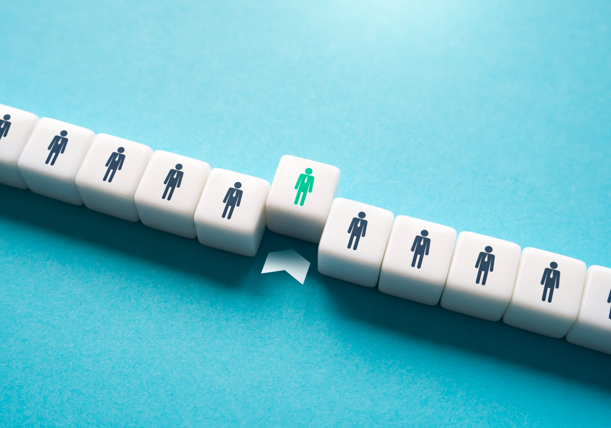 Highlighted employee standing out from a row of identical figures for nomination