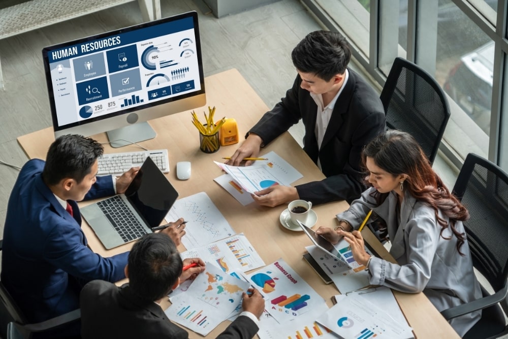 HR team analysing employee recognition data and cultural insights through reporting and analytics tools.