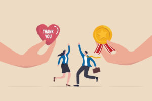 Illustration showing employees celebrating recognition, with hands offering a thank you heart and achievement medal symbolising appreciation and reward-based retention strategies.