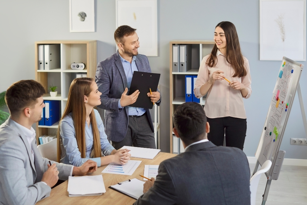 Manager presenting a strategy plan to team members during a collaborative workplace meeting