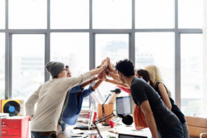 Team collaboration reflecting improved workplace culture through recognition