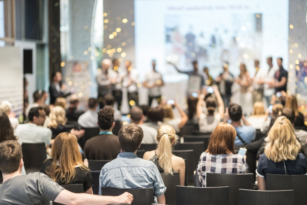 Audience attending a workplace recognition and leadership event