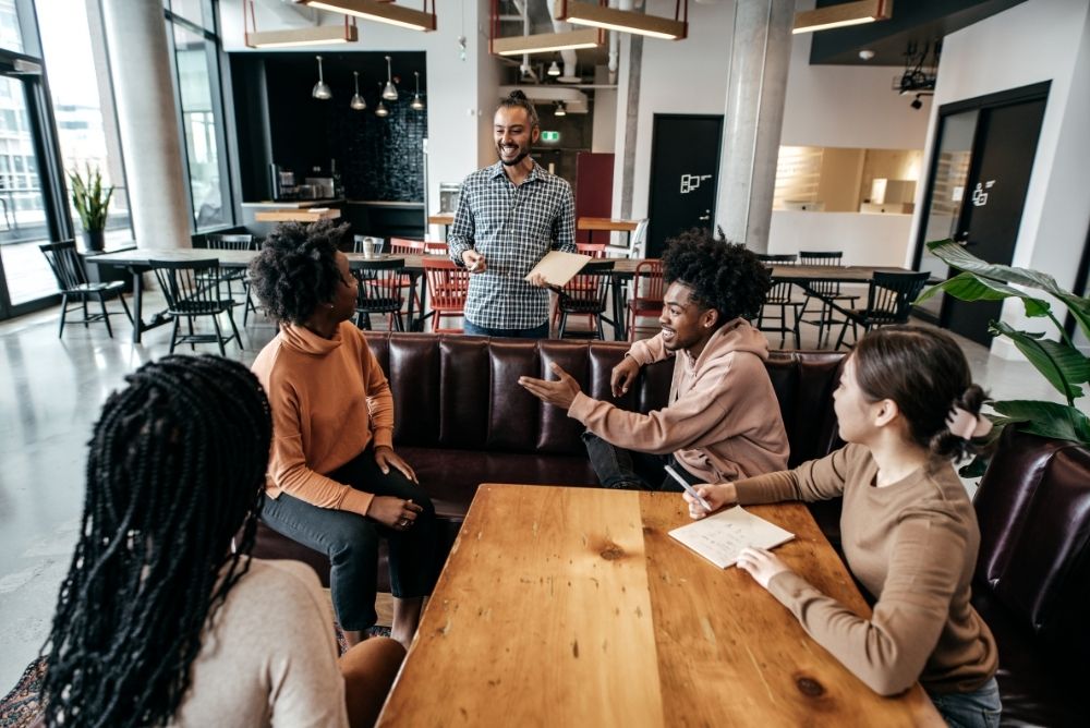 Employees sharing ideas during a casual team meeting at work